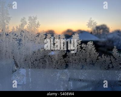 Frost on a window at sunrise Stock Photo
