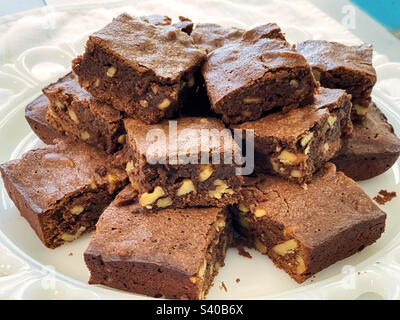 Stack of homemade fudge brownies served on a white plate. Stock Photo