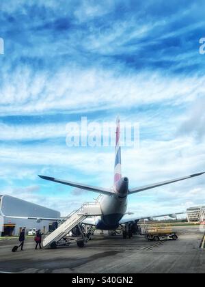 Boarding the plane - people boarding a British Airways City Flyer aircraft from the tarmac on stairs Stock Photo