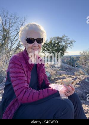 Active senior taking a lunch break at the top of a hiking trail at Inks Lake State Park Texas Stock Photo