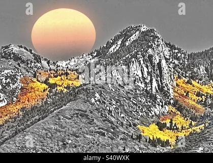 The majestic Wasatch mountain range, sitting just east of the Salt Lake Valley in Utah, USA, during the autumn. Color select yellow foliage pops against the B&W. Faded sun disc has been digitally add. Stock Photo