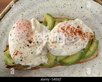Poached egg and avocado on toast Stock Photo