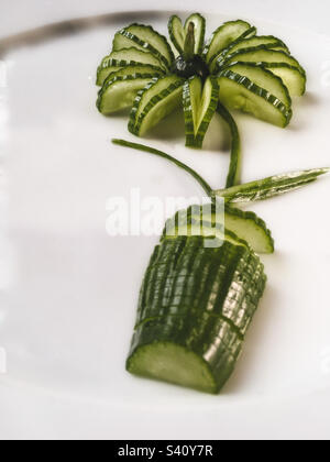 Flower cucumber on a pot on white plate Stock Photo