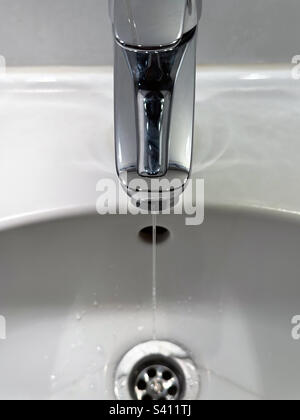 Open water tap in bathroom Stock Photo