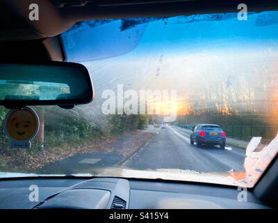 Looking forwards through a frosted windscreen in a parked car on a winter’s morning in The UK Stock Photo