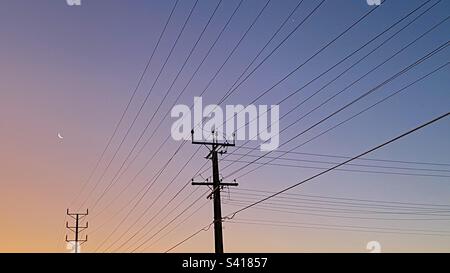 Telegraph poles at sunset Stock Photo