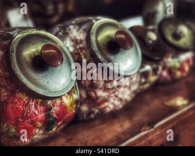 Old candy jars on a wooden counter in a General Store Stock Photo