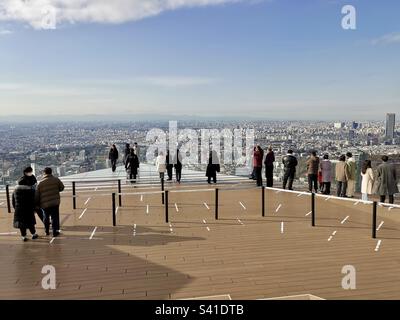 Tourists enjoying the views of Tokyo from the Shibuya Sky on top of the Shibuya Scramble square skyscraper in Tokyo, Japan. Stock Photo