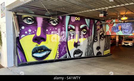 LOS ANGELES, CA, JUN 2022: Beautiful mural depicting three women's faces, on the wall of a garage entrance in Melrose District Stock Photo
