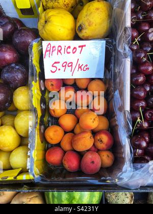 Apricots priced up for sale at Grocers shop Stock Photo