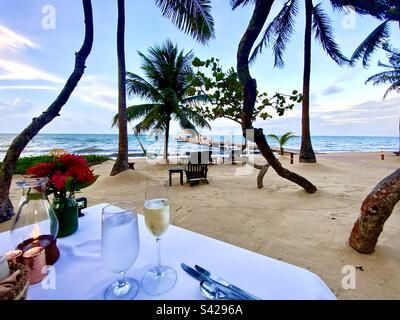 Sunset champagne dinner set up on the beach Stock Photo