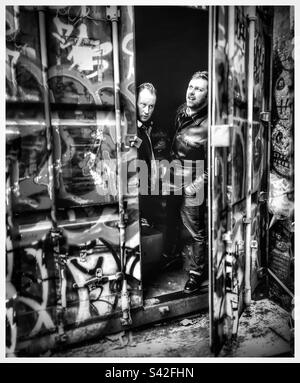 Two guys looking out of a container in Peckham. Stock Photo