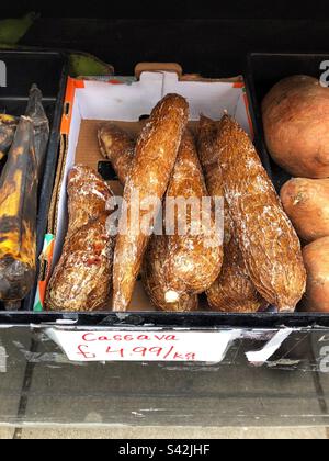 Cassava, yucca, priced up for sale at Grocers shop Stock Photo