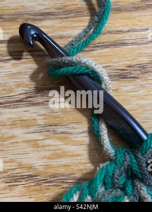 Double strands of yarn wrapped around a crochet hook Stock Photo