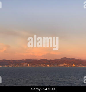 November, 2022, sunset view from a cruise ship leaving Ensenada, Baja California, Mexico Stock Photo