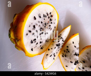 Close up of a honey dragon fruit slices on a cutting board Stock Photo