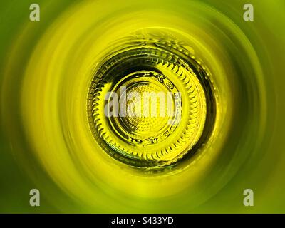 Bottom of a wine bottle seen through the neck of the bottle. Abstract. Stock Photo