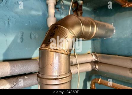 damaged stainless steel chimney pipe carrying flue gas from the gas boiler Stock Photo