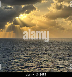 Rays of sunlight through the clouds over the Gulf of Mexico, seen from the deck of a cruise ship Stock Photo