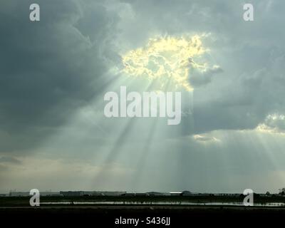 Sun radiation through a hole in the cloud. Taken with my iPhone 14 pro max Stock Photo