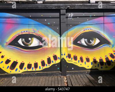 Street art - colourful painted eyes in the shape of a butterfly. Stock Photo