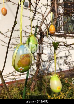 Easter- Painted eggshells hang in a garden in Poland to celebrate the Christian festival of Easter Stock Photo