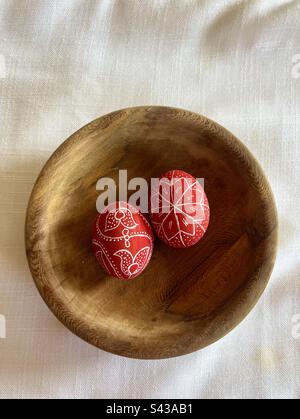 Two 2 dyed painted eggs in wooden plate for Easter Stock Photo