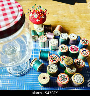 Old cotton reels and mushroom pin cushion Stock Photo