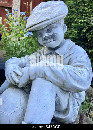 Stone statue of a boy Stock Photo