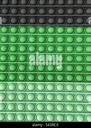 Abstract back of green and black rubber circles and lines Stock Photo