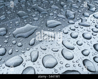 Rain drops on grey metallic surface Stock Photo