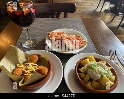 Tapas and sangria at Güell Tapas, Barcelona, Cataluña, Spain. April 2023. Stock Photo