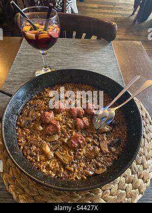 Butifarra (Catalan Sausage) paella and sangria at Güell Tapas, Barcelona, Cataluña, Spain. April 2023. Stock Photo