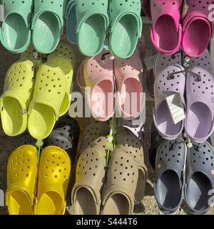 Rows of colourful plastic sandals, or sabots on sale in a French Street market Stock Photo
