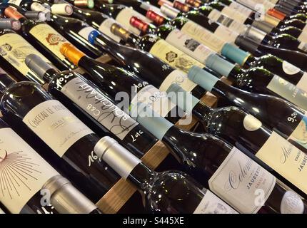 Rose of bottles of fine vintage wines in a French wine merchants warehouse. Stock Photo