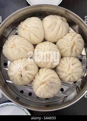 Eight asian pork buns in stainless steel steamer, where they just cooked, now ready to be served Stock Photo