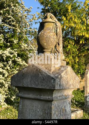 Close up of carved urn on top of an ornate graveyard headstone, st Nicholas’ church, Abbotsbury, Dorset, England Stock Photo