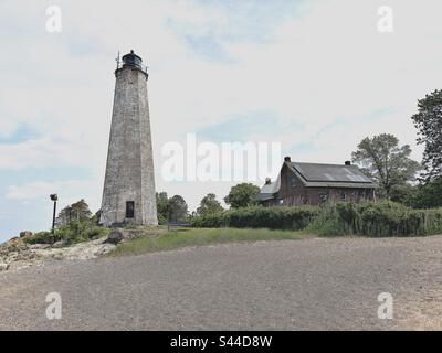 New Haven, Connecticut, USA: Lighthouse and red house at Lighthouse Point Park with small beach area. Stock Photo