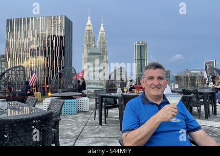 Tops and spires of Petronas Twin Towers and the smaller Petronas Tower 3 or Carigali Tower Four Seasons and EQ Hotels seen from KL Helipad rooftop bar in KLCC Kuala Lumpur Stock Photo