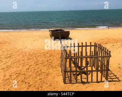 Boat and anchor on beach Stock Photo