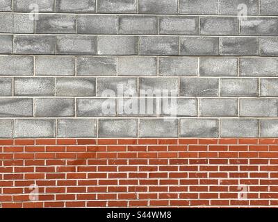 Pattern formed by concrete blacks and house brick in the wall of a building. Backgrounds. Stock Photo
