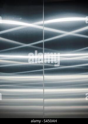 Full frame abstract background shot of led light reflections on metal surface. Pattern. Close-up. Stock Photo