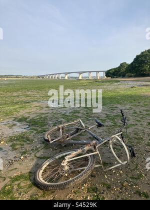 Abandoned bike under the Orwell Bridge, Ipswich, Suffolk, UK. Stock Photo