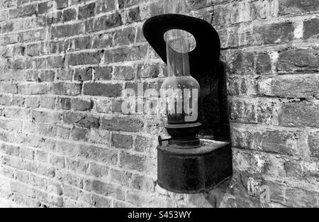 An old paraffin lamp fixed to the wall in the Windmill museum De Valk in Leiden in the Netherlands Stock Photo