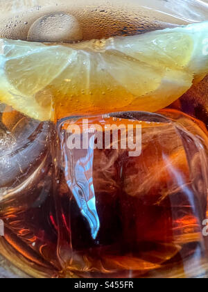 Ice cubes and lemon in glass of ice cold cola Stock Photo