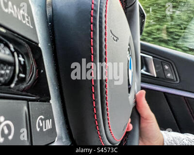 Driving a BMW car with close up of M sport steering wheel Stock Photo