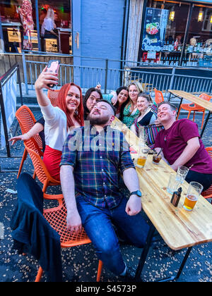 Group of friends taking selfie on night out in Leeds City Centre Stock Photo