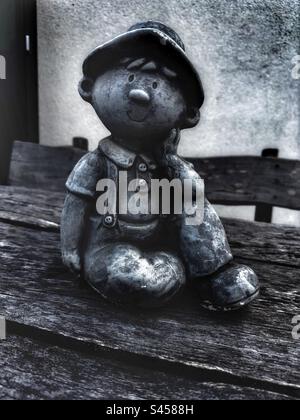 Boy stone statue sitting and smilling Stock Photo