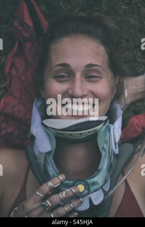 Young woman smiling with neck brace on Stock Photo