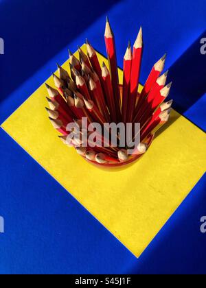 Set of graphite pencils with points up on yellow and blue background Stock Photo
